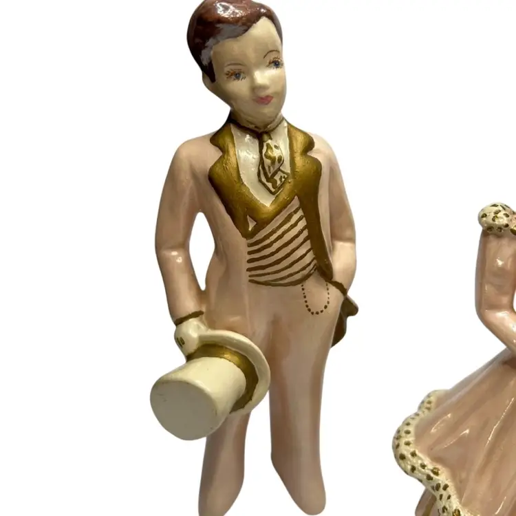 Pink And Gold Chalkware Couple Repair To Ladies Head Some Damage On Gentleman’s Bottom Of Pant Leg 
@7x7 1/2” Tall
