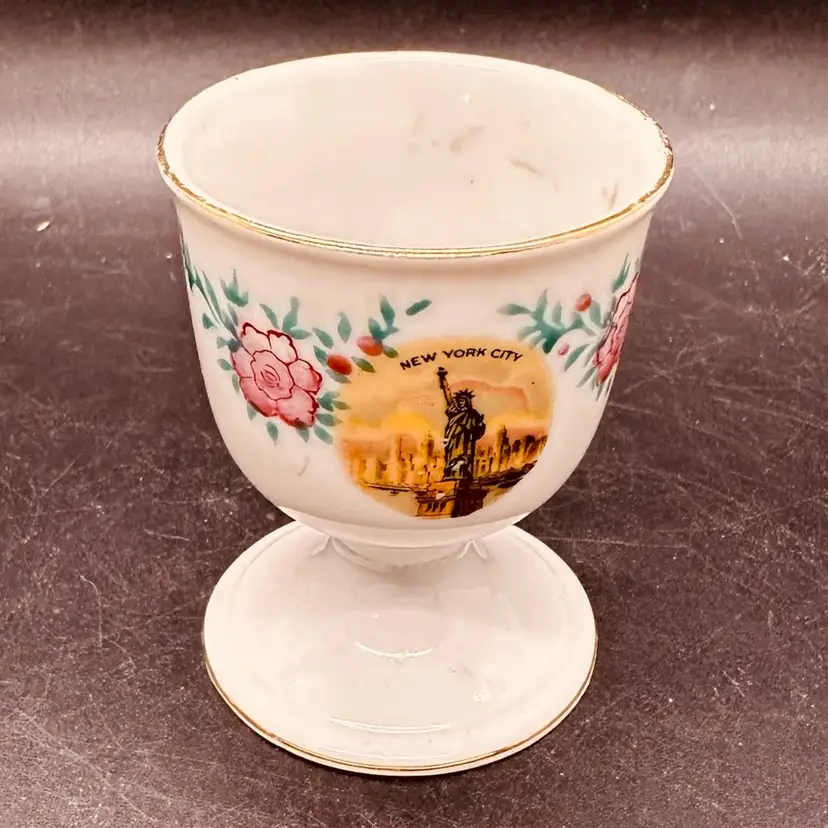 74. Vtg Porcelain egg cup featuring State of Liberty and text "New York City" surrounded by floral patterns