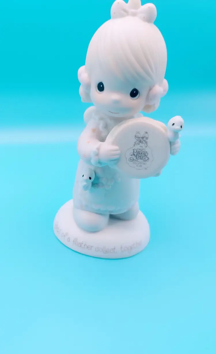 Precious Moments figurine titled "Birds of a Feather Collect Together," 1986.