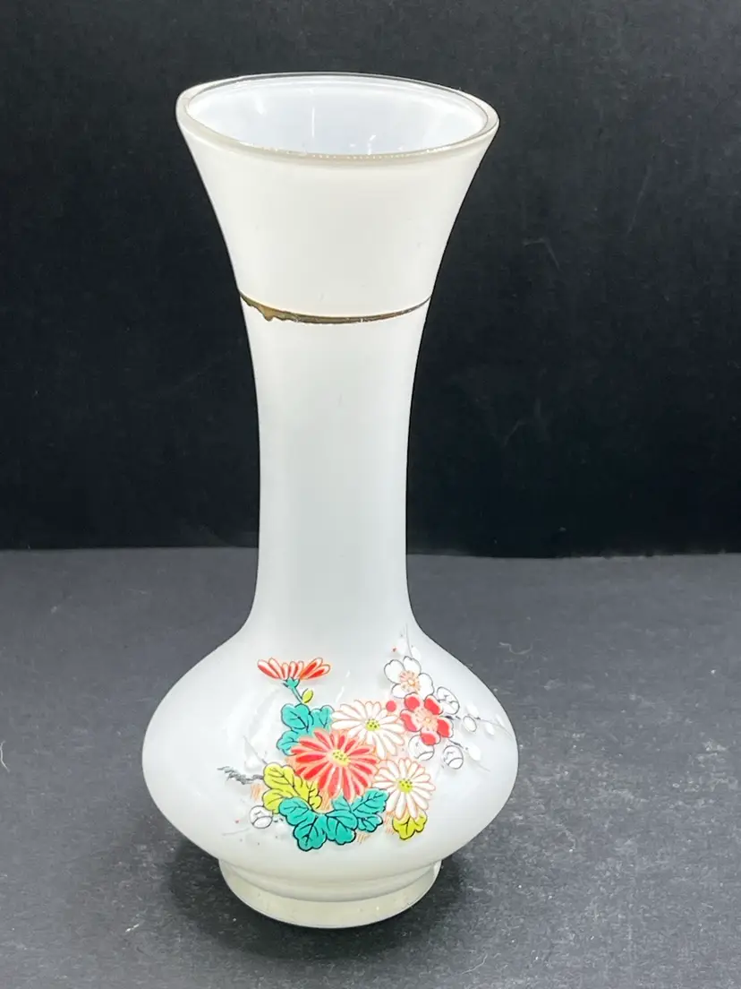 This is a vintage White glass vase with hand-painted floral designs.