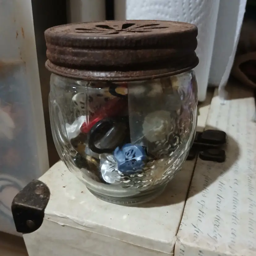 Vintage jar with lid full of vintage buttons