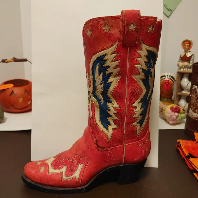 Cowboy boot planter. Some damage at the top of the boot.