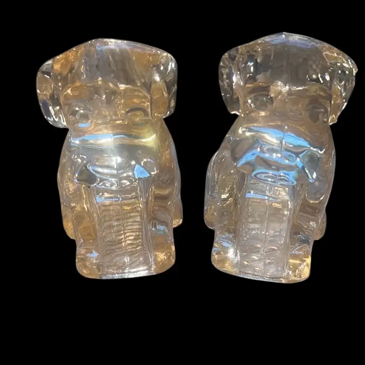 Two light pink glass, hollow dog figurines 3 inches tall has a unique pinkish tent to the glass and some glow with UV light