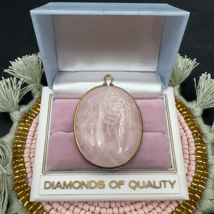 Hand Carved Oval Rose Quartz Pendant framed In Brass