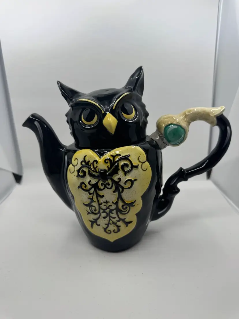 A Blue Sky Clayworks black ceramic wizard owl teapot with decorative scrollwork 2011
