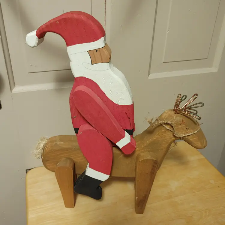 Wood Santa riding a Reindeer. Santa does come off. 17 inches high.
