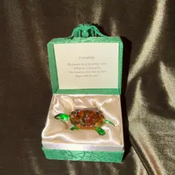 A hand-blown glass turtle figurine with a friendship poem.