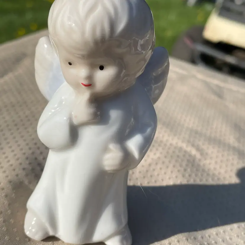 Little Angel Thinking With Finger By Mouth.