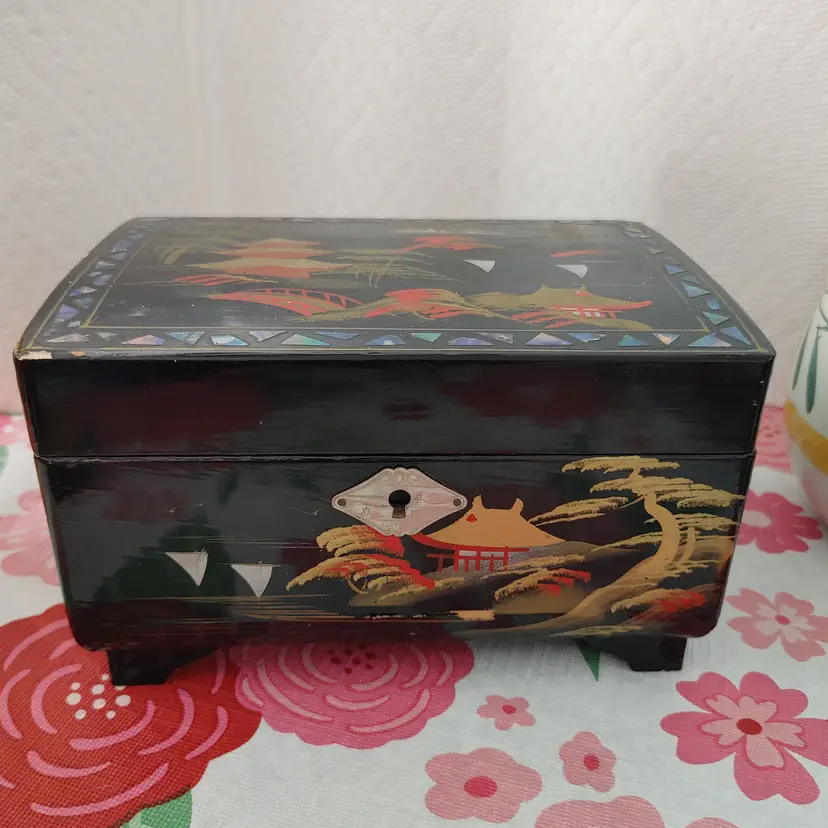 Vintage Japanese hand painted black lacquer jewelry box. Has mirror and blue velvet lining. Some minor paint loss.