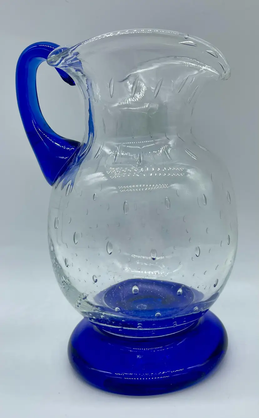 Hand blown clear Mexican art glass small pitcher with controlled bubbles.