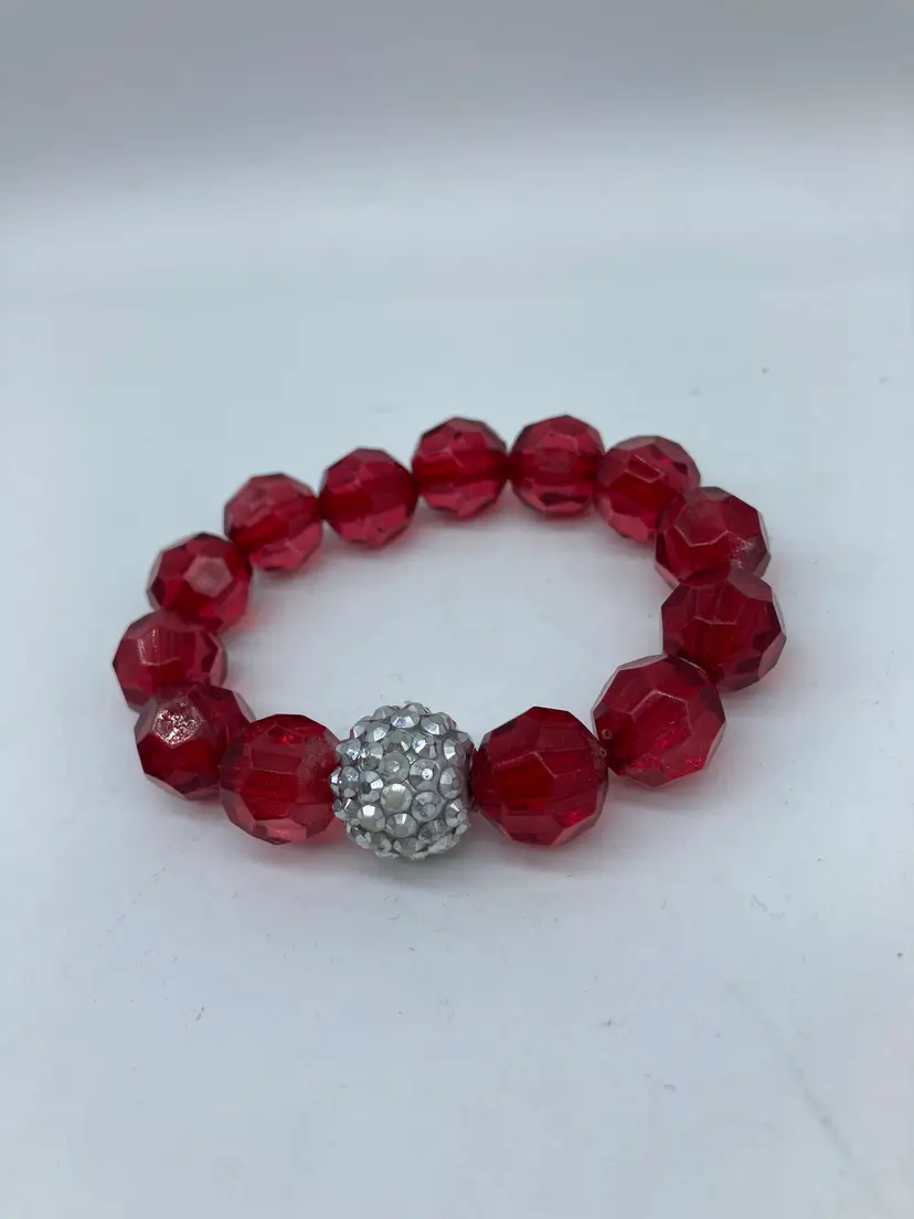Red plastic bead bracelet with center silver bead cut to look like bling, stretch