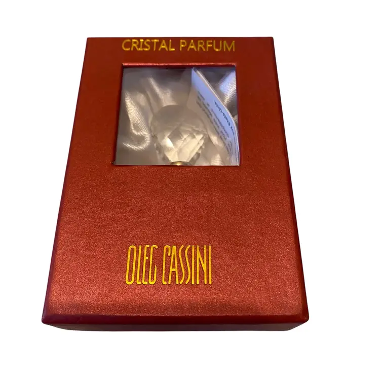 This item is a vintage Oleg Cassini Cristal Parfum bottle featuring a diamond-shaped cut crystal design and a signature stopper