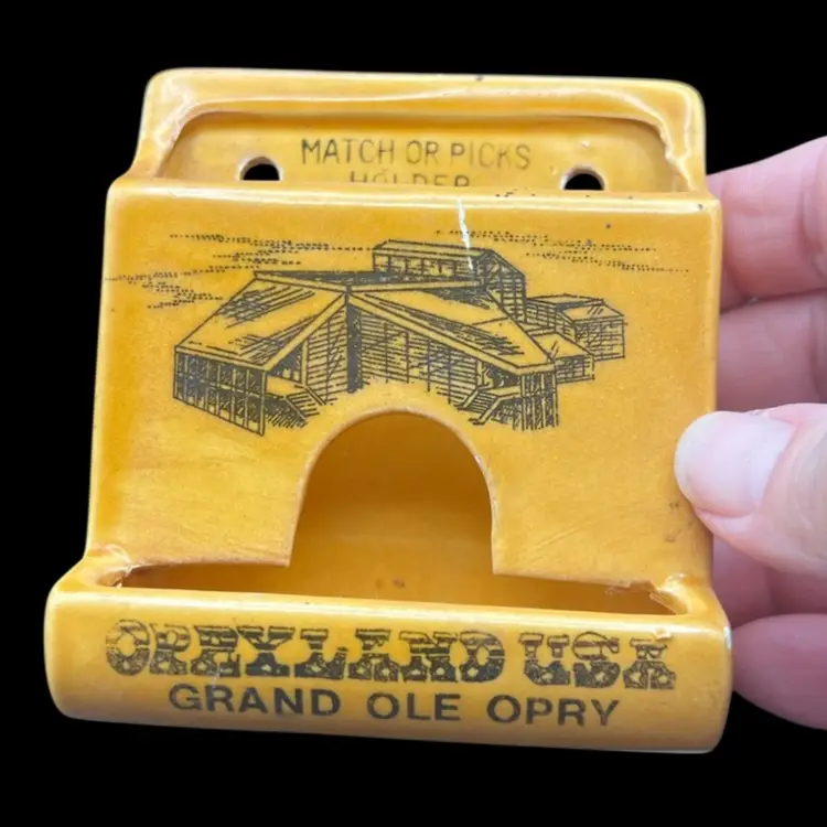 #260B Vintage Yellow Baked Enamel Over Ceramic Match Or Toothpick Holder 
Souvenir From Opryland USA, Grand Ole Opry 
Made In Japan
