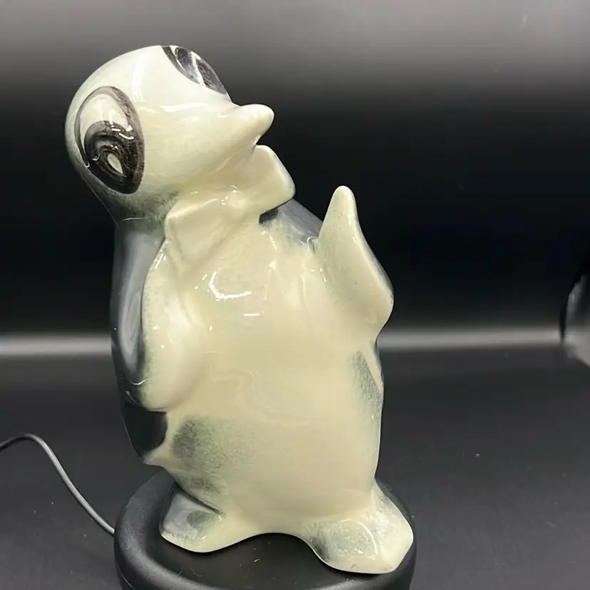 This is a vintage Anthropomorphic ceramic penguin figurine/planter/vase With Bow Tie No Makers Mark Approximately 7” Tall