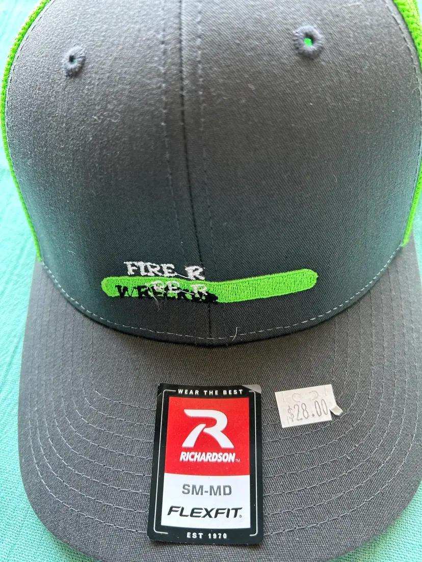 A Grey and fluorescent green FlexFit hat