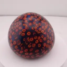 Orange and cobalt blue millefiori paperweight