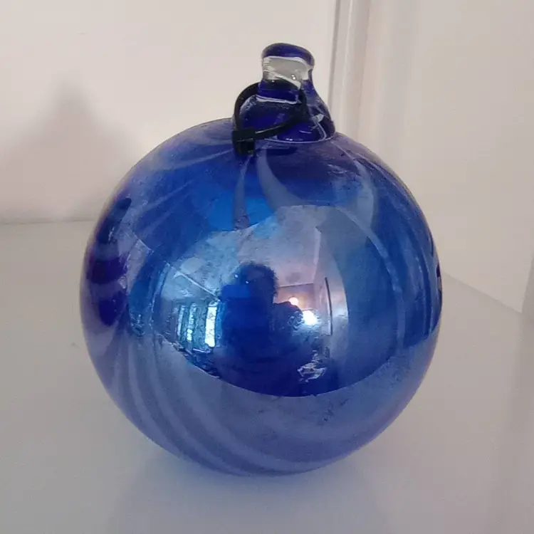 Blue glass orb, pulled drape design