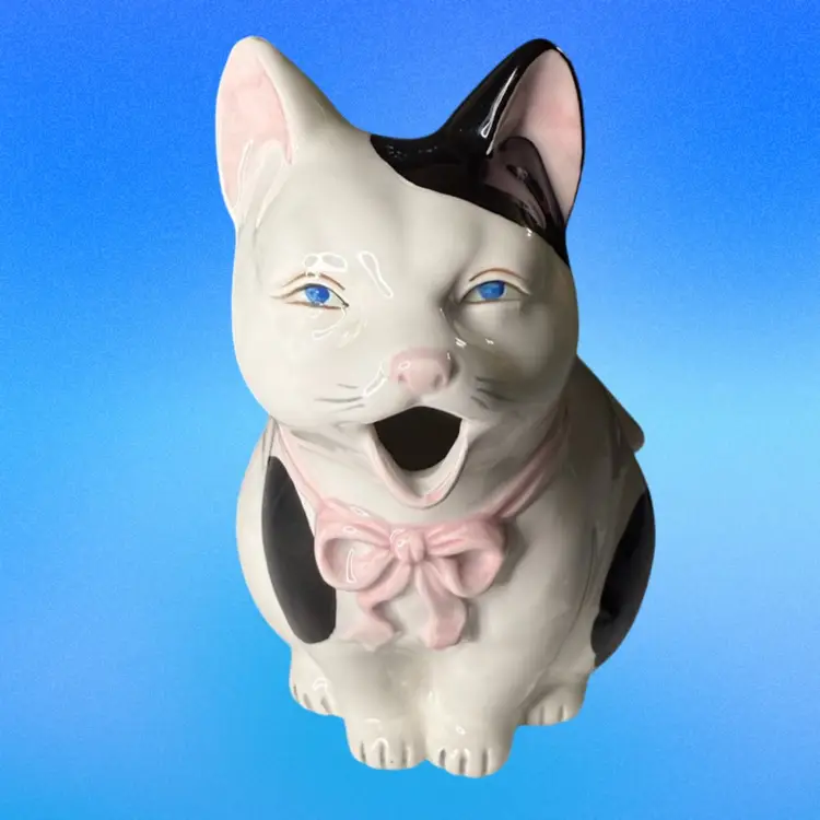 Cat Teapot Takahashi San Francisco Hand Painted  Ceramic White Black Spots Pink Bow & Blue Eyes
6 -1/2” T x 7” L x 4-1/2” W