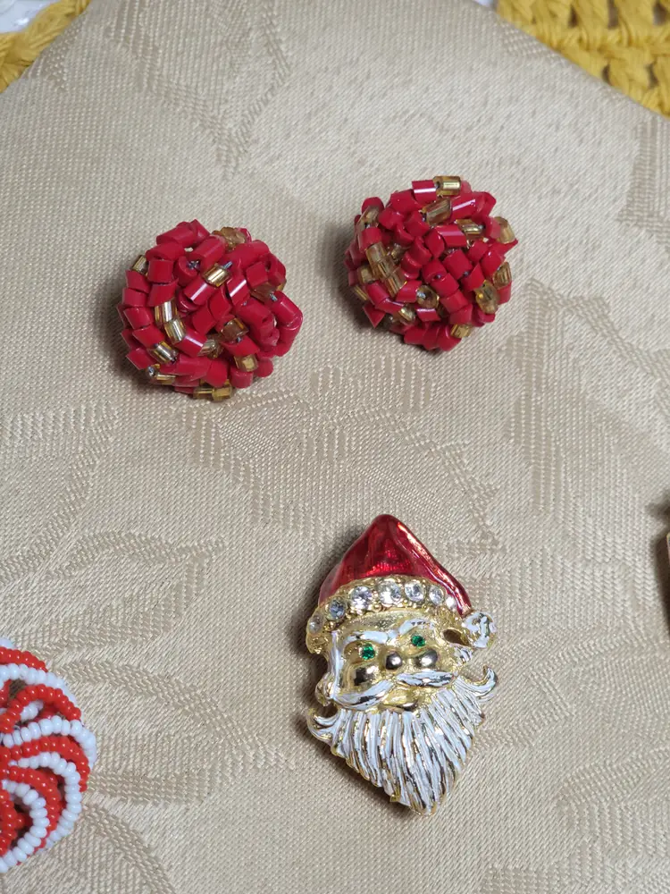Lot of Christmas earrings a couple small brooches and a signed Avante Santa brooch