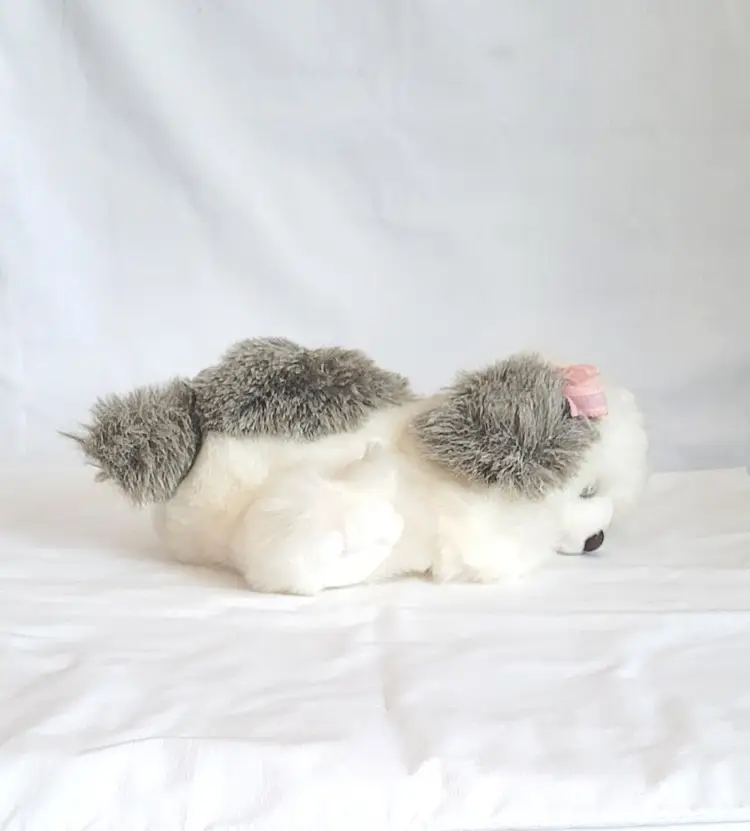 Reclining Gray and White Stuffed Toy Dog