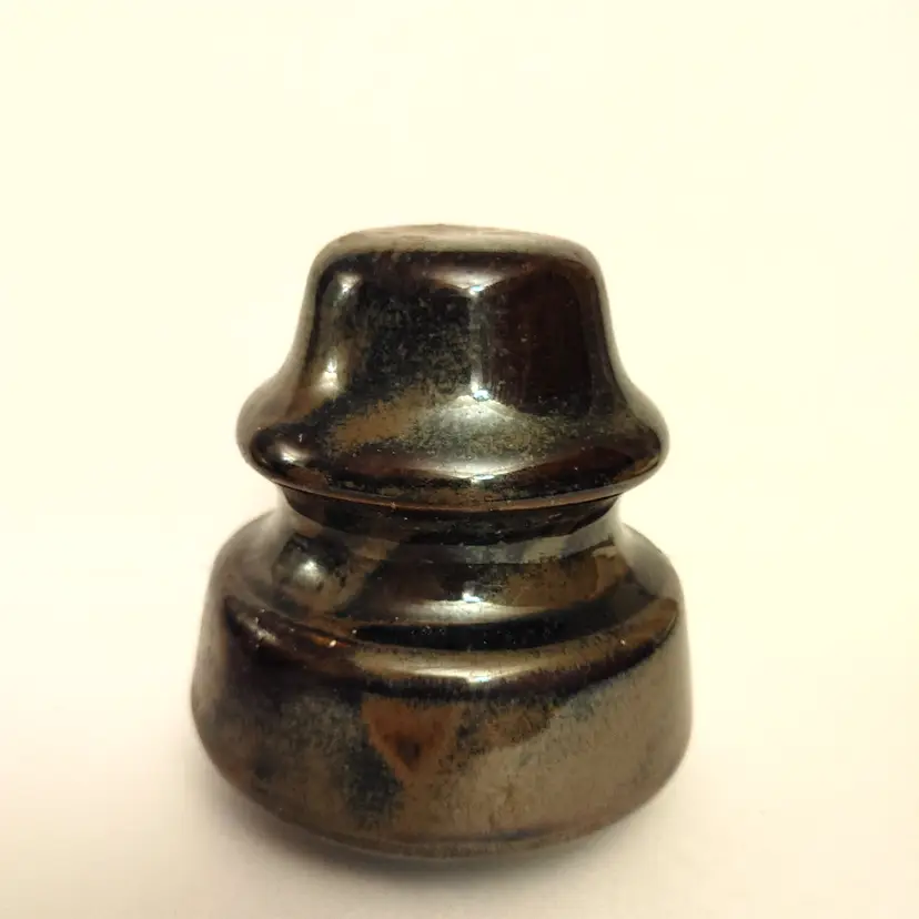 Brown ceramic insulator. 4 inches high.