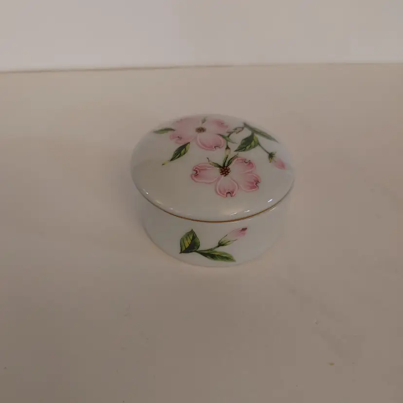 Trinket dish with flowers. Says Atlanta. Bottom says TWE. 2.25 inch diameter. No chips or cracks.