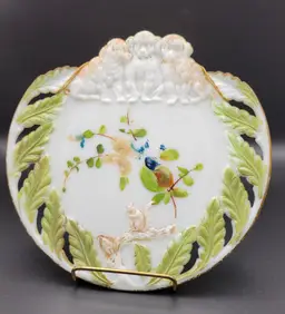 Antique hand painted milk glass plate with puppies and squirrel.