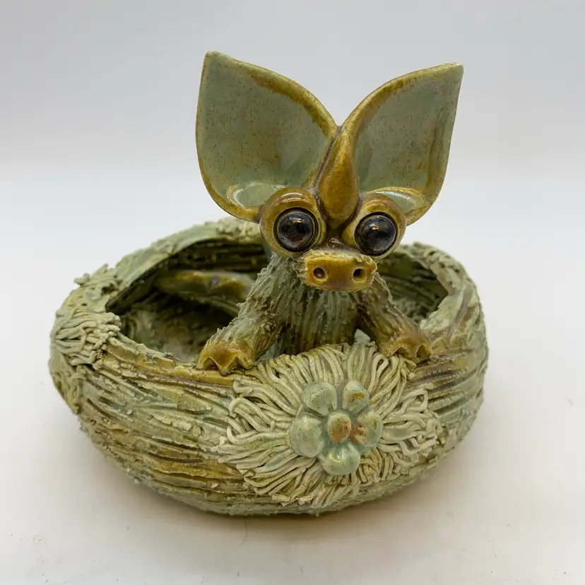 #2254 Yare Pottery ceramic dragon figurine nestled in a textured nest.