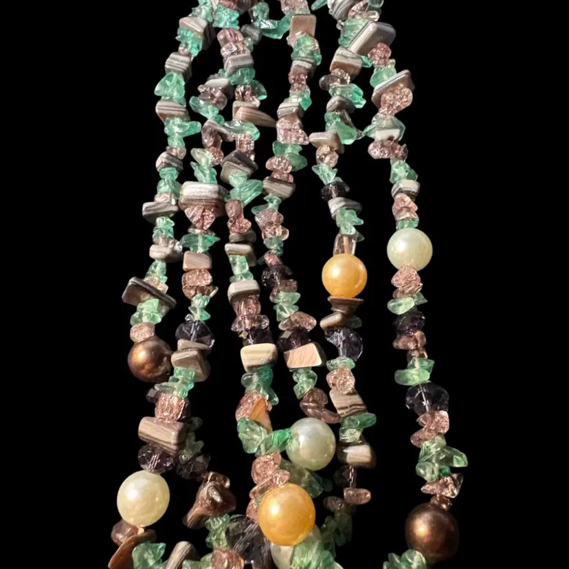 This is a layered necklace made with green and pink chip beads With Shell ByChico