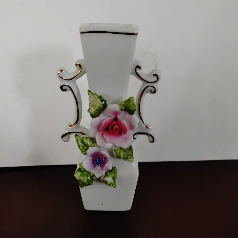 Ceramic bud vase with flowers and gold trim. No chips or cracks. 5 inches high.