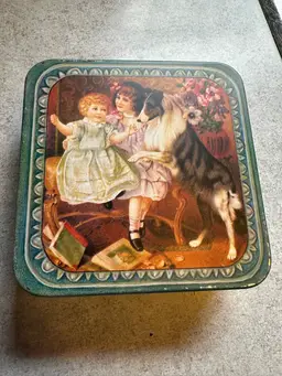 Vintage decorative tin with Victorian-era children and collie dog illustration.