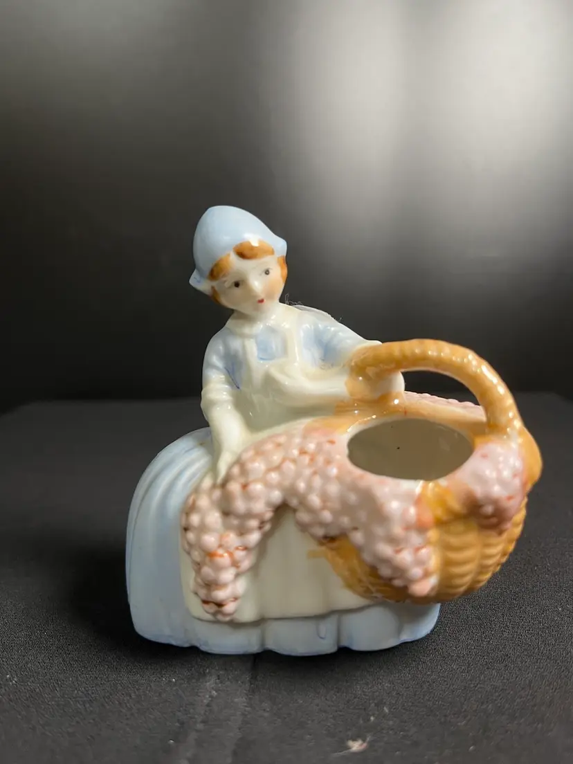 Porcelain, Made in Japan, Young Girl in Billowing Blue Dress w/ White Apron Carrying a Basket Overfilling w/ Grapes