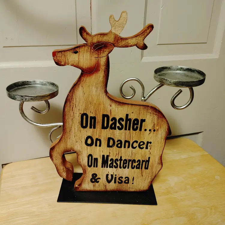 Wood reindeer candle holder. Fun saying! 13 inches high. Part of antler is chipped.