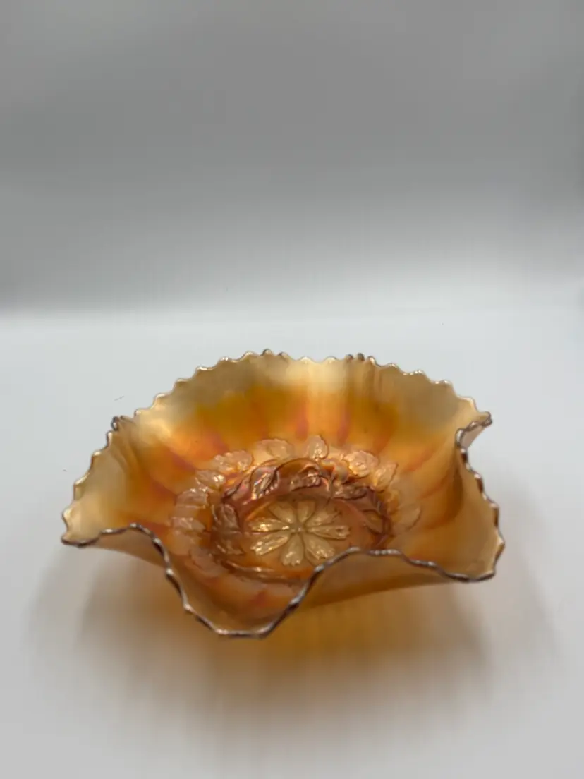 Dugan “Diamond cosmos” 9 in ruffled fruit bowl in marigold carnival glass