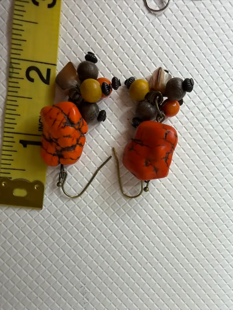 Earring With Orange And The Button Does Have One She’ll Each