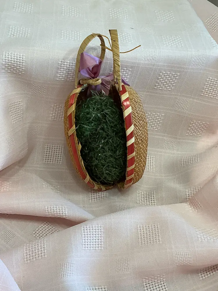 Woven wicker egg with chicken painted on both sides closure and vintage grass inside
