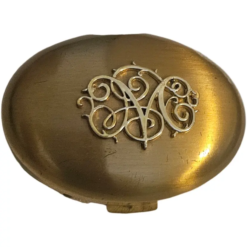 vintage Germaine Monteil goldtone oval compact with raised filigree design