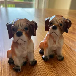 A pair of vintage ceramic boxer puppy figurines. 4” Tall