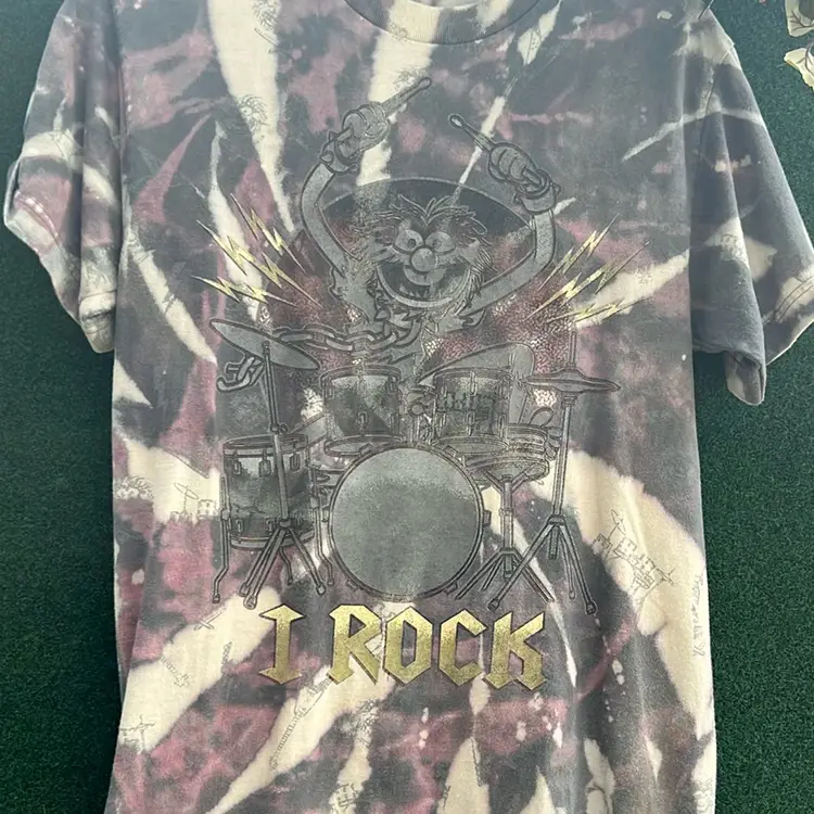Sesame Street Animal, I Rock, Drum Set. Purple And White Tie-Dye Shirt With Animal, Guitar And Drum Set Imprinted Throughout The Tee. 