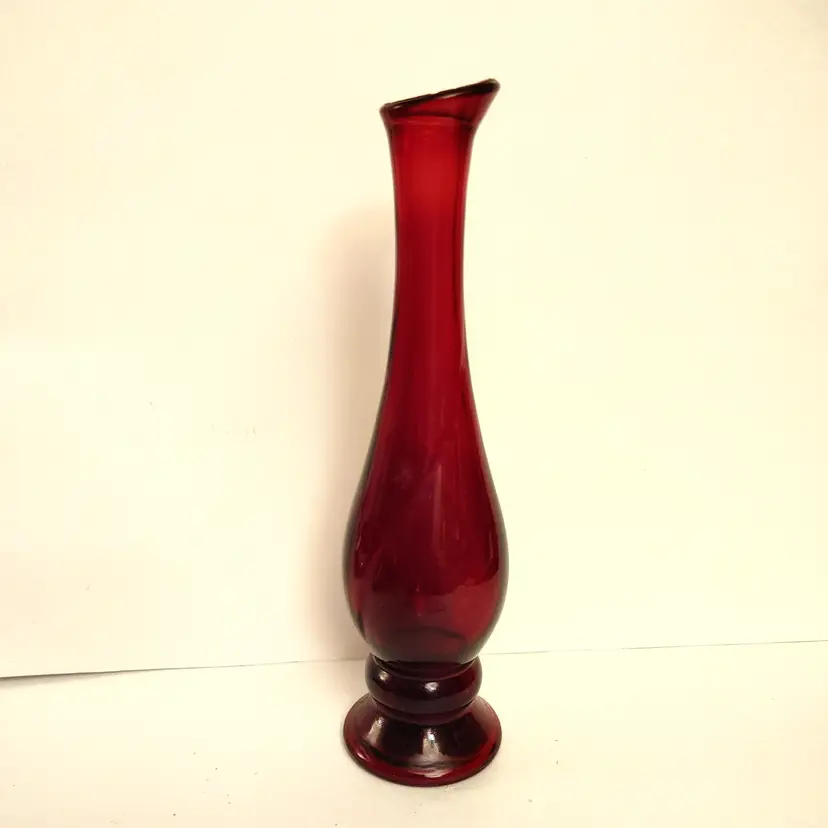 Avon vintage ruby red glass bud vase. 70's. 7.75 high. Small chip on rim.