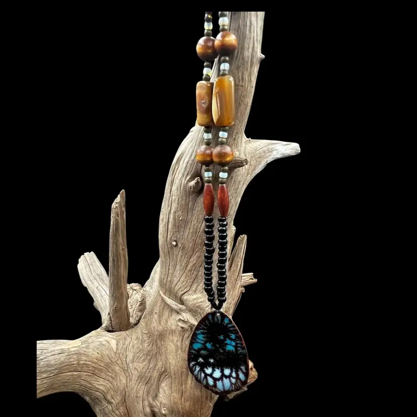 #343B Beautiful Artisan Made Beaded Necklace With Enamel On Copper Pendant 
Wood, Glass And Stone Beads. 
Signed On The Back L. Toal 
Necklace Has A Barrel Clasp And Is 28” Long, Pendant Is Just Over 2” Long