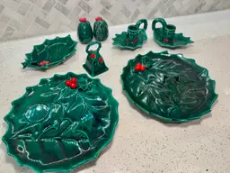 CHOICE $12, collection of vintage Lefton Green Holly ceramic Christmas dishes, including 1 plate, 1 tray, 1 trinket dish, a bell, set of candle holders, and salt/pepper shakers, likely from the 1960s or 1970s.
