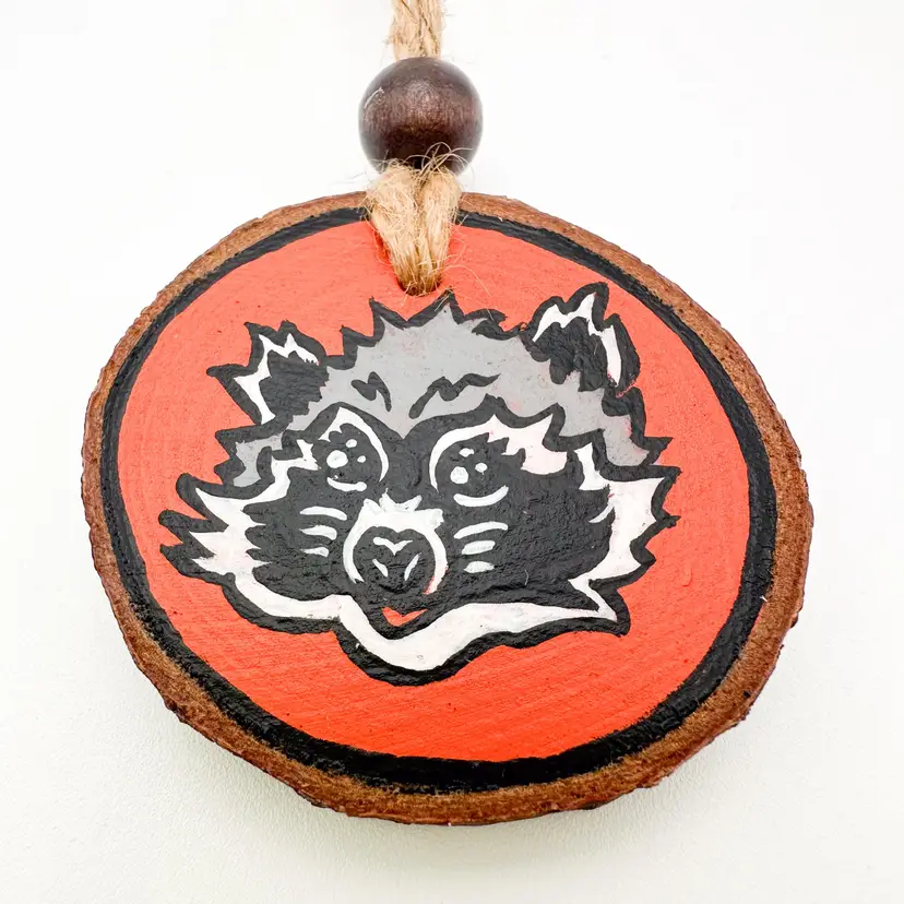 Niknax Raccoon Logo Hand Painted Wood Ornament 2" D