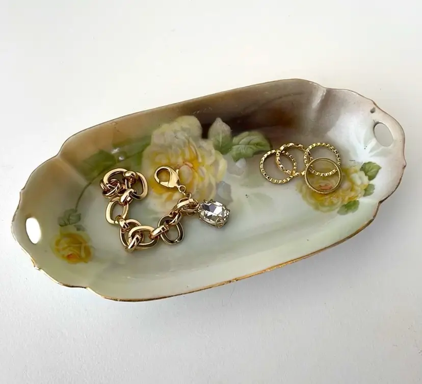 Beautiful china trinket dish for storing rings/bracelets/keys on your bureau, QTips and lip balm on your vanity, etc. Made in Germany. Yellow roses, grey/brown accents, white base. 8.5”x3”x1” (Jewelry, etc. for display only)