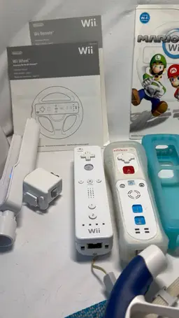 Wii 3 Games 2steering Wheels 3 Controllers 4 Controller Covers 2
 Nunchucks Wii Instruction Booklet