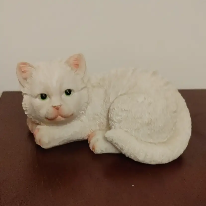 White cat figurine with pink accents. 5.5w x 2.5h x 3.75d. No condition issues.