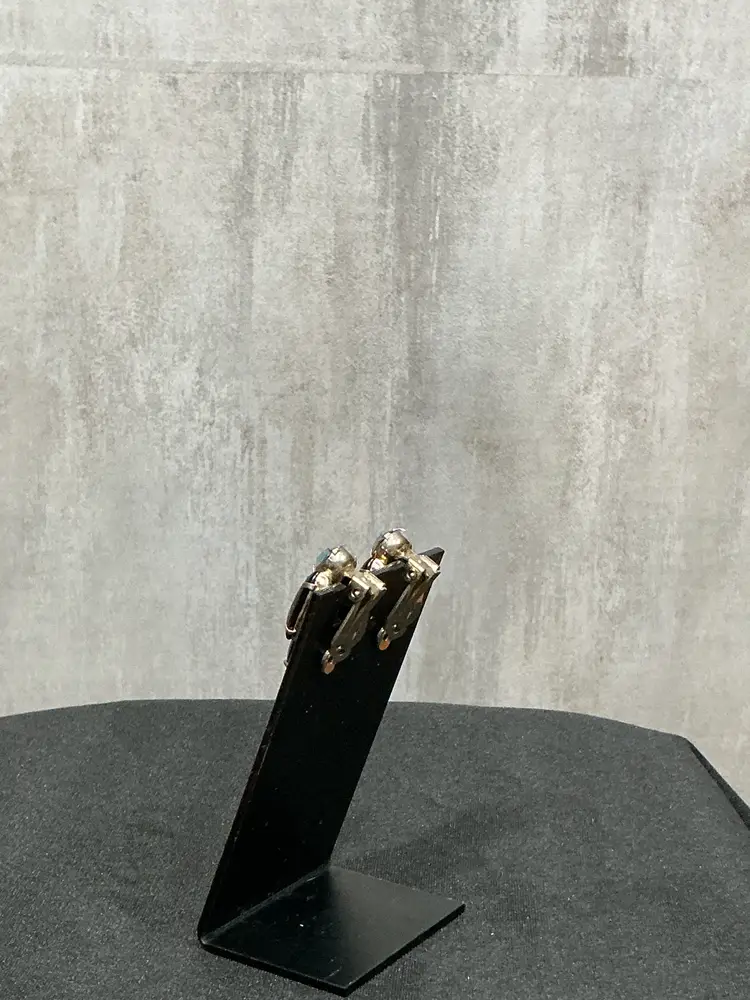 clip-on earrings featuring glossy black navette stones accented with sparkling Aurora Borealis rhinestones. Dramatic mid-century cocktail glamour with excellent shine. Secure clip backs. Perfect for evening or statement wear.