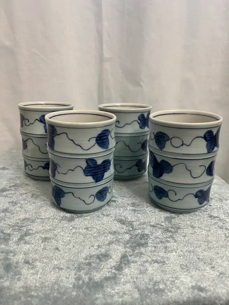 Set of 4 Japanese Yunomi tea cups, specifically identified as Arita ware (also known as Imari ware) due to their origin in the Arita region and their traditional blue and white design