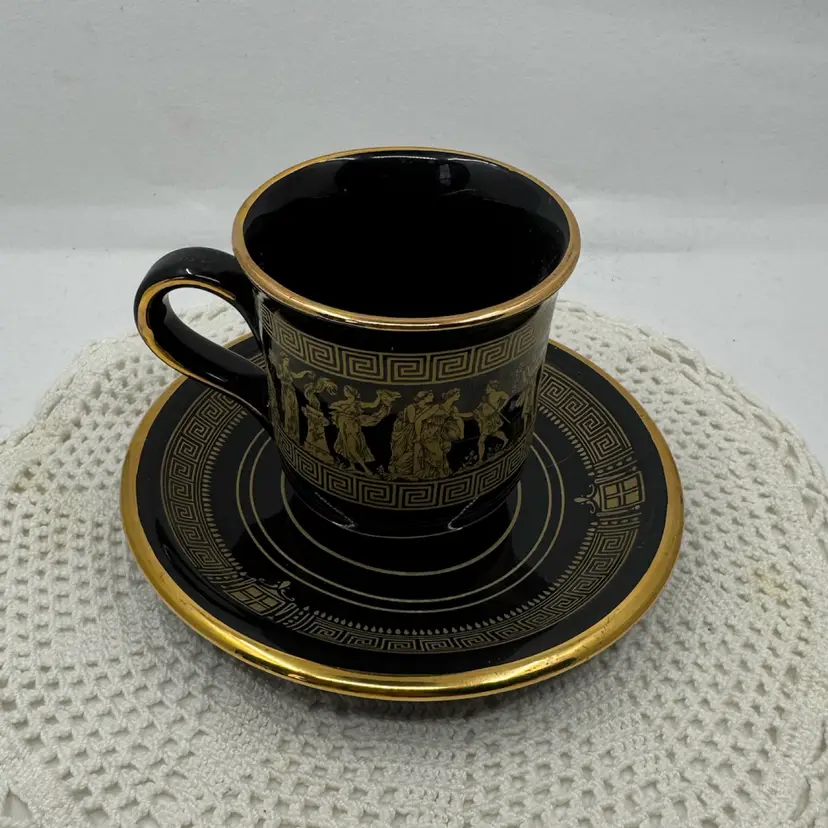 Black ceramic cup and saucer set with gold accents And Greek Motifs, Small Callout On Rim Of Cup