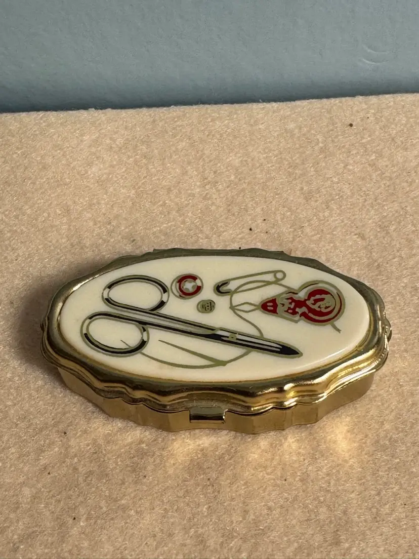 Vintage enameled sewing trinket box with gold-tone metal trim